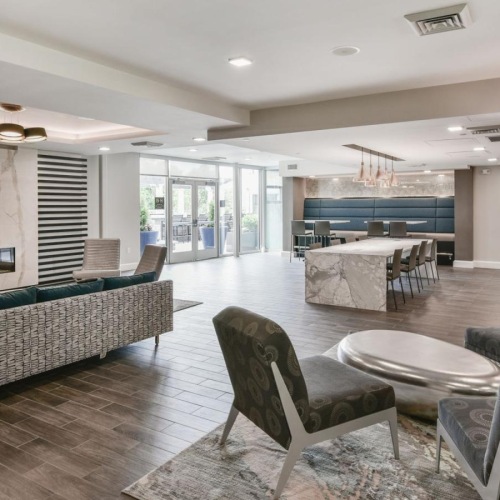 Enjoy our resident-only features a living room with a large glass door and a large dining table